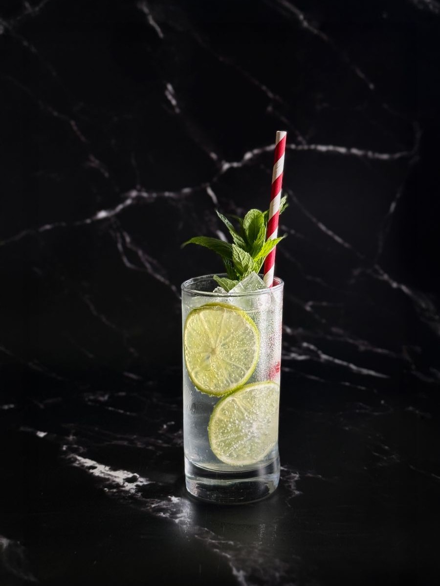 Kosci & Soda cocktail with mint and lime in highball glass